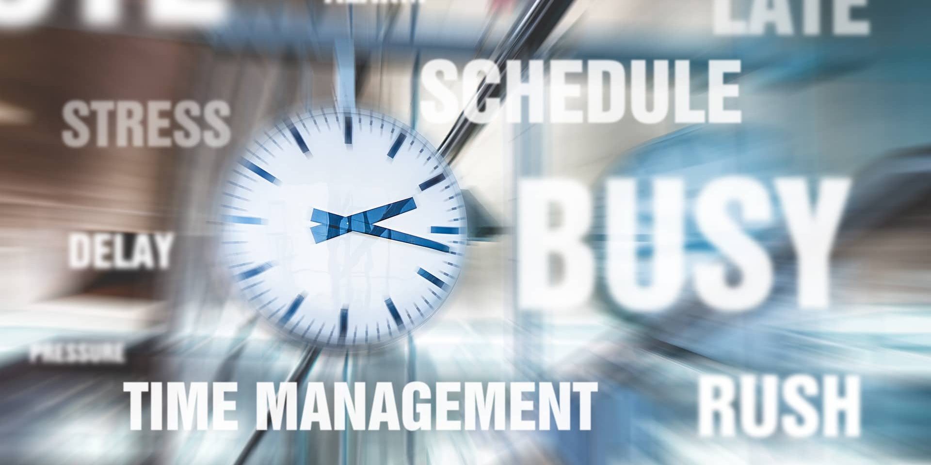 Blurry picture of clock with words stress, time management, schedule, busy, rush, delay, late, overtime around it